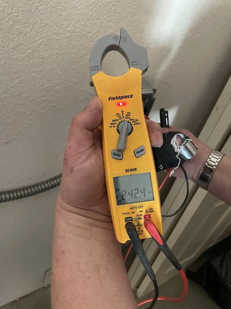 Voltage testing with clamp meter during Whole House Surge Protector in North Terre Haute
